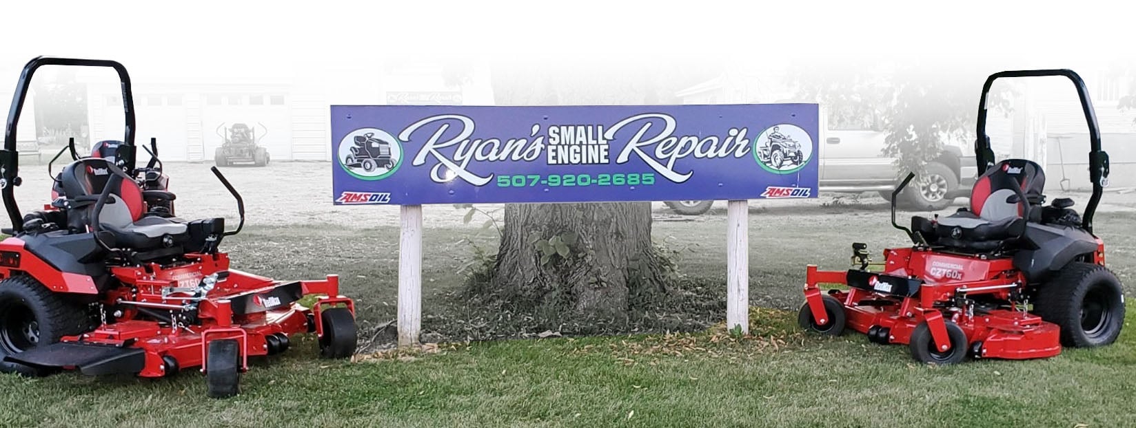 Ryan's Small Engine Repair sign with mowers next to it.